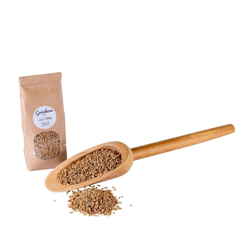 Grünkern ganz, lose und in Holzlöffel dargestellt