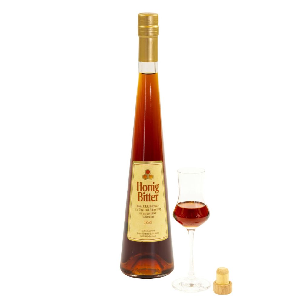 Honigbitter in der Langhalsflasche mit Schnapsglas