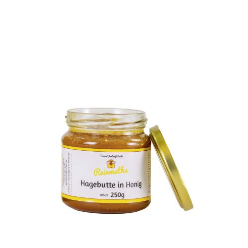 Hagebutte in Honig im Glas mit offenem Deckel