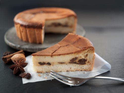 Kuchen angeschnitten, Stück steht davor, dekoriert mit Anis, Muskat, Zimtstange